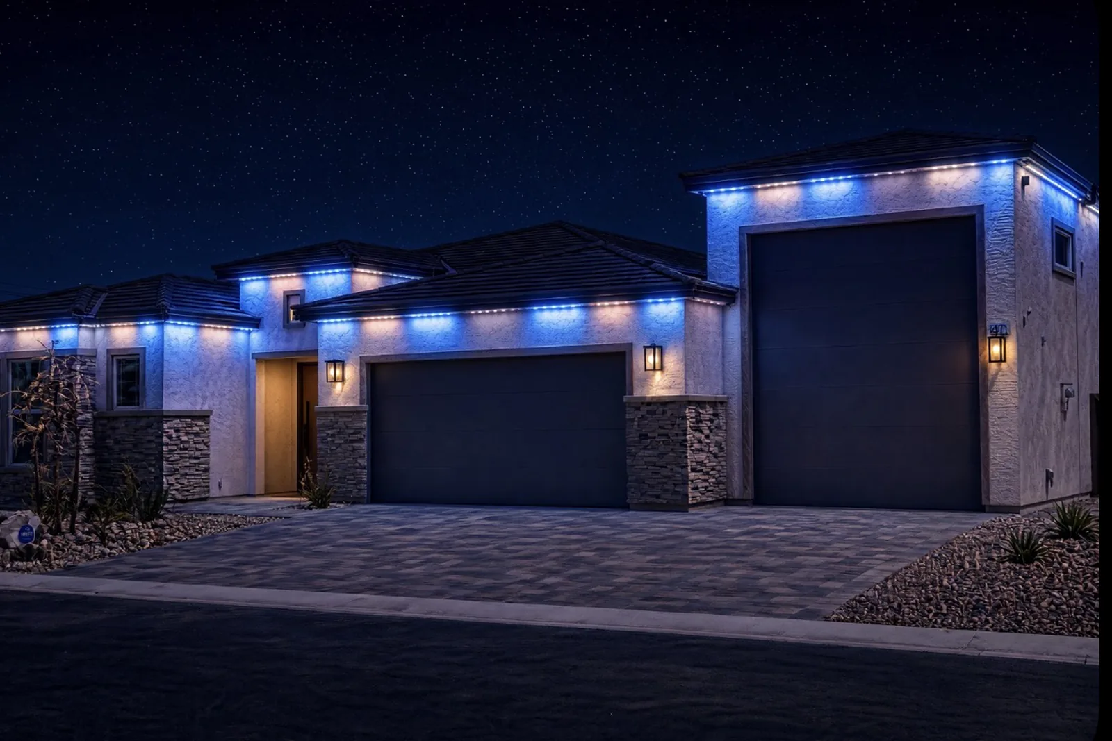 The same home after dark with the permanent roofline lighting switched on